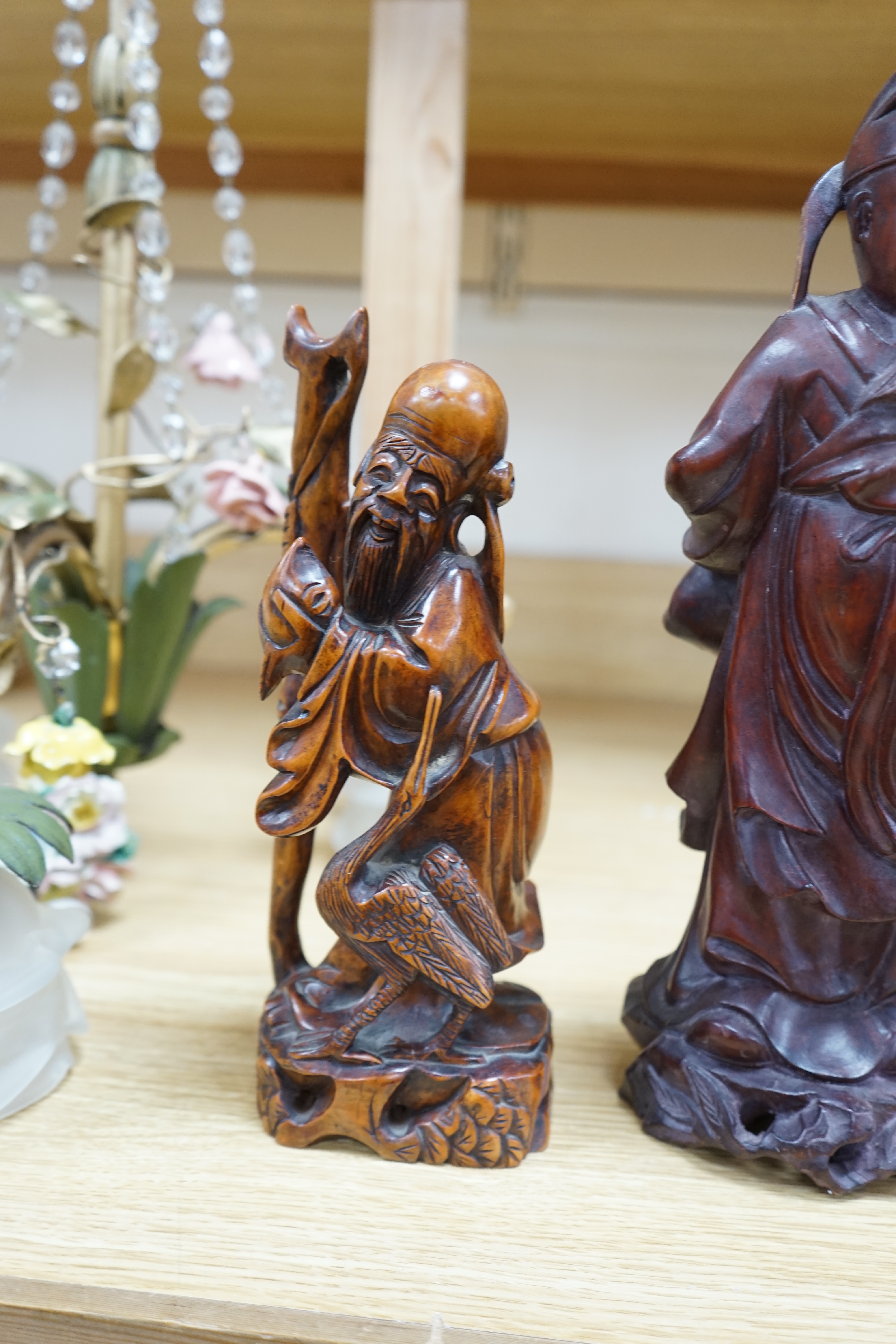 Two Chinese hardwood carved figures and a soapstone figure of Guanyin, largest 37cm high. Condition - fair